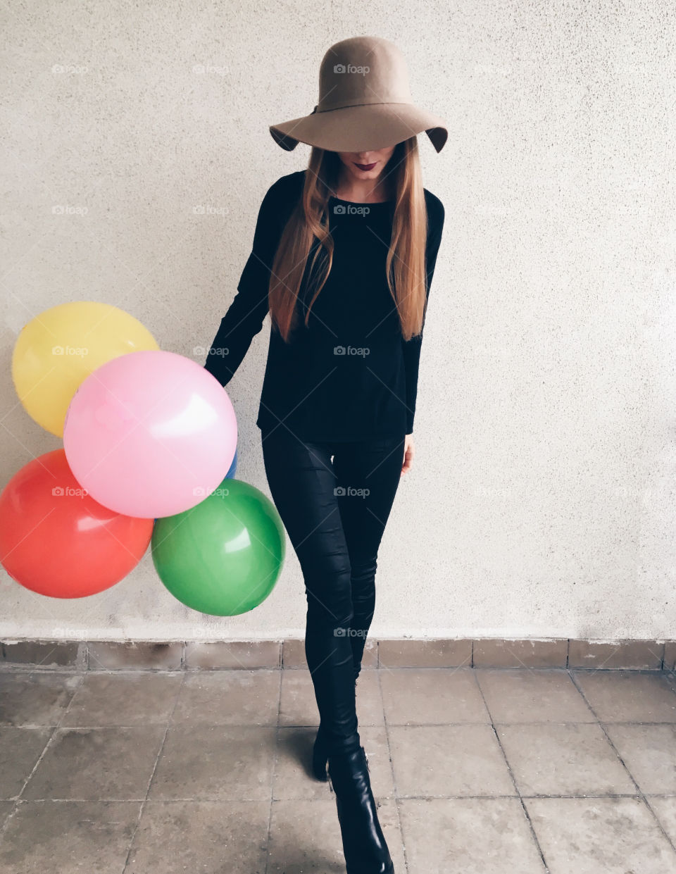 Young woman with colorful balloons 