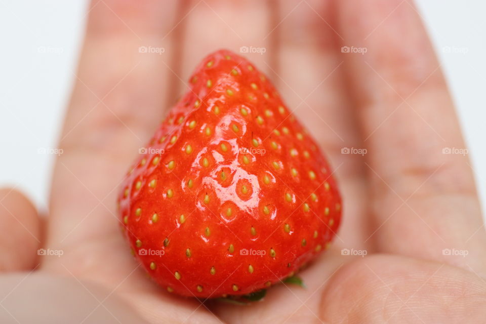 A strawberry on hand