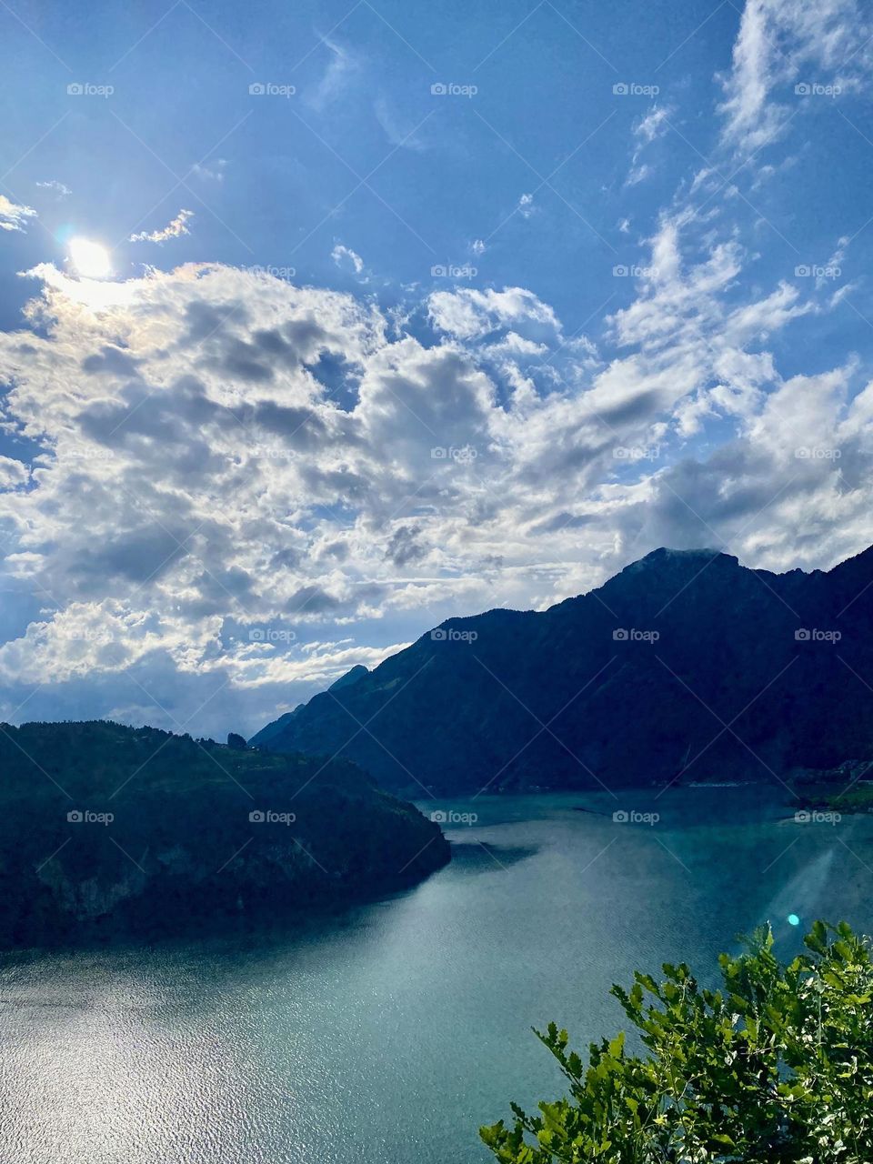photo from above of a beautiful landscape in switzerland, mountains, lake, rocks, trees