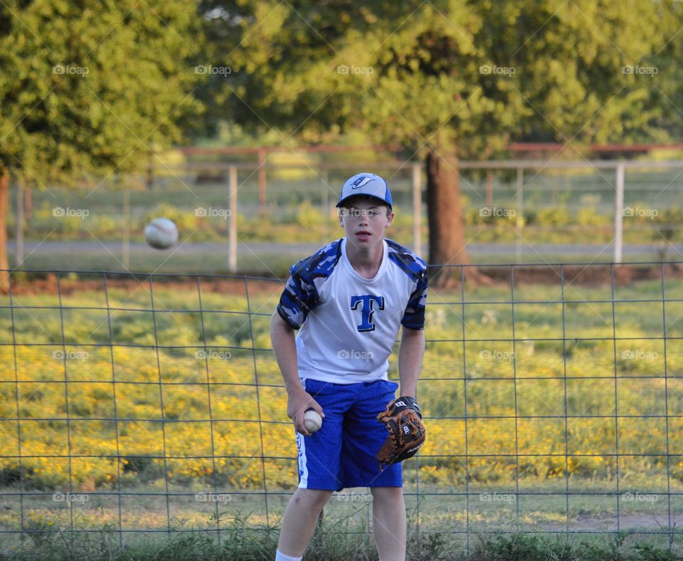 Teenager boy playing baseball