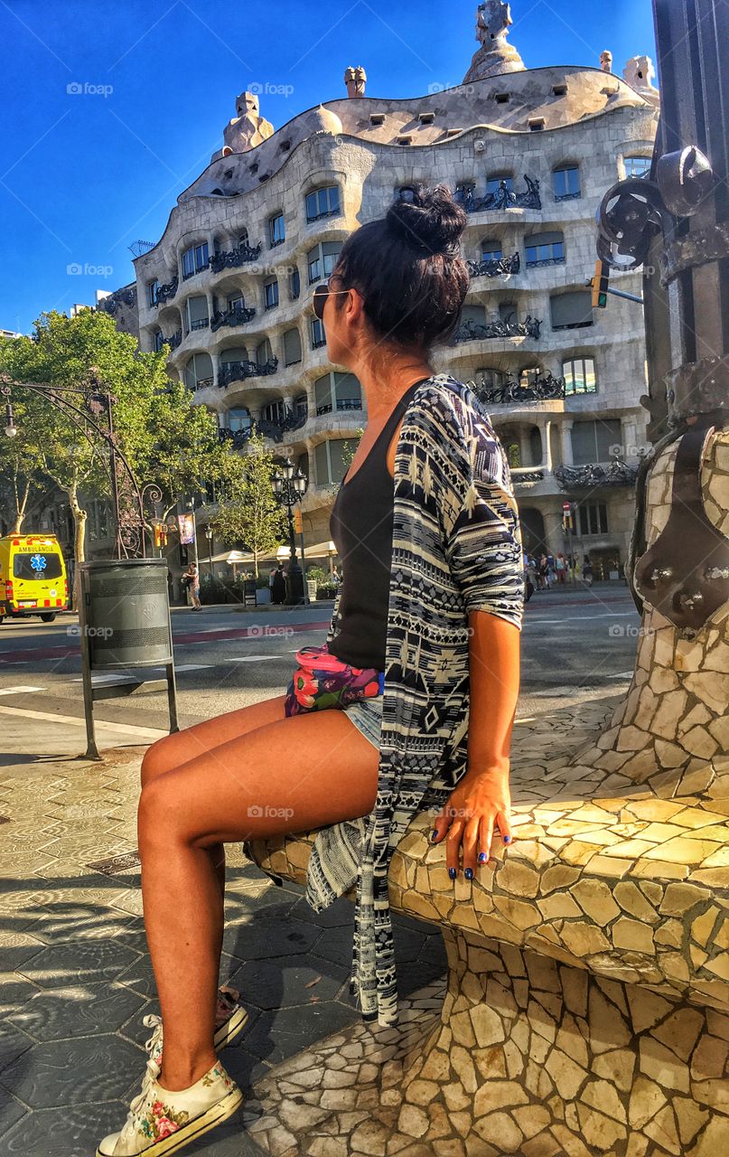 A girl looking at the unique building created by Gaudi 