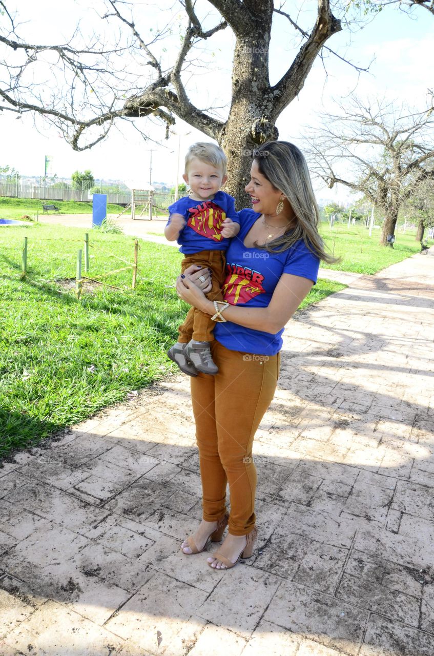 joy in the park mother and son playing and smiling
