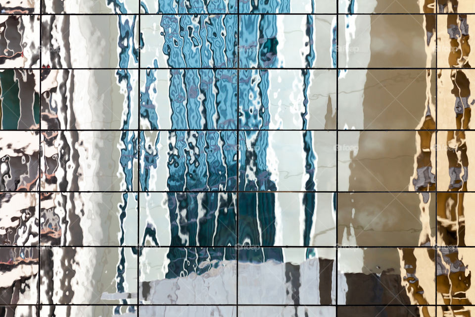 Abstract reflection of buildings in glass exterior window