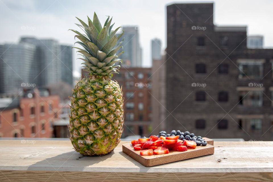 Close-up of pineapple with slice's of berry fruits