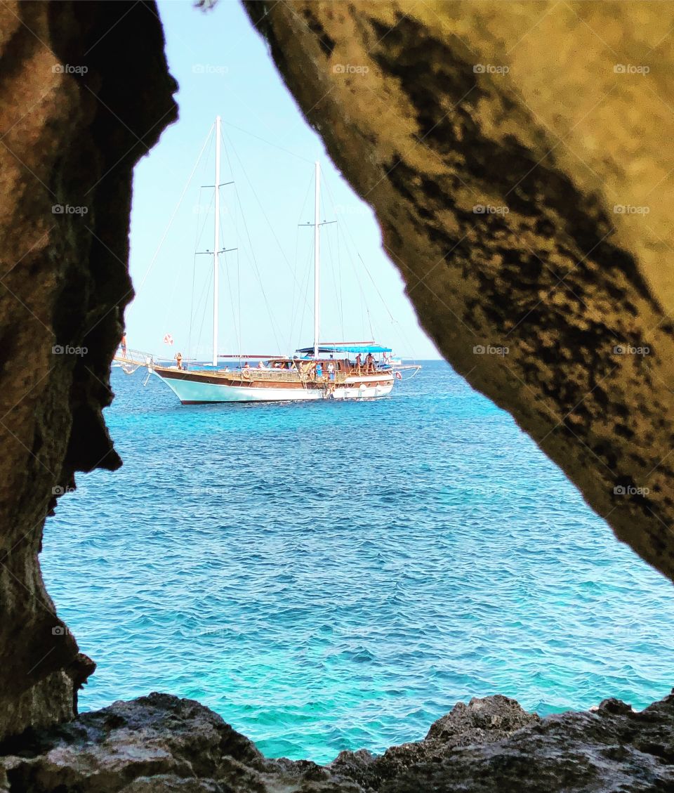 Sailboat through rock hole, Favignana, Sicily 