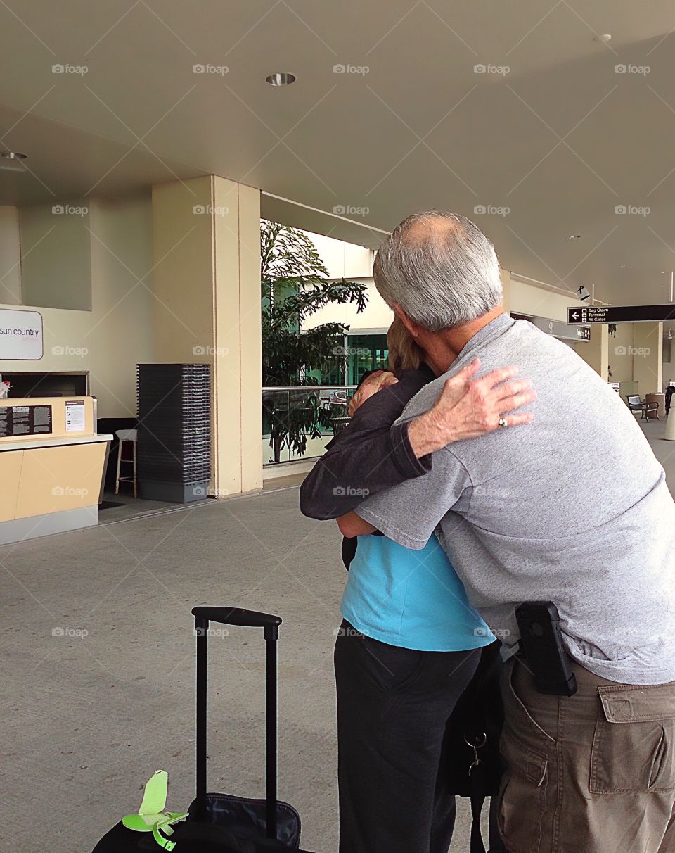 Joyful family reunion at the airport between a Mother and her Son.