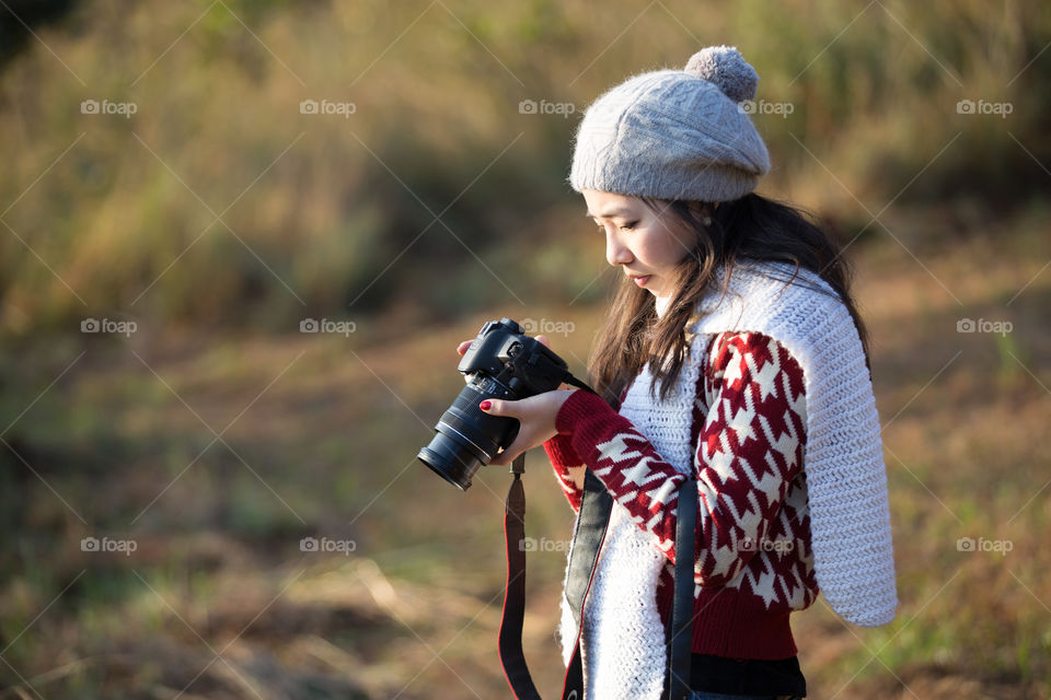 Asian girl looking at the camera in the field 