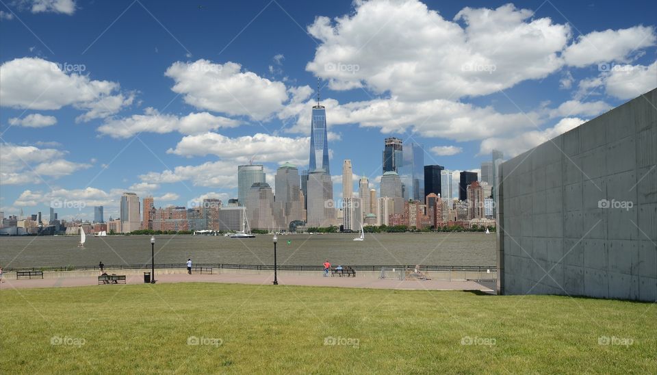 The New york city skyline can be seen across the Hudson river from Liberty State park.