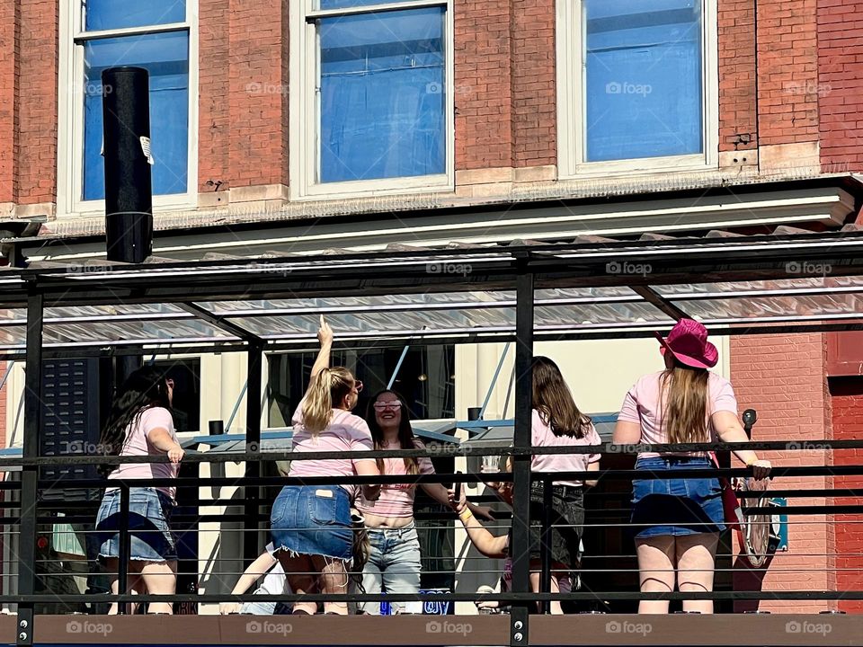 Girls weekend party in Nashville, United States. Women riding a party bus enjoy the revelry on lower Broadway!