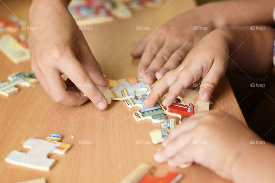 Person putting puzzle together