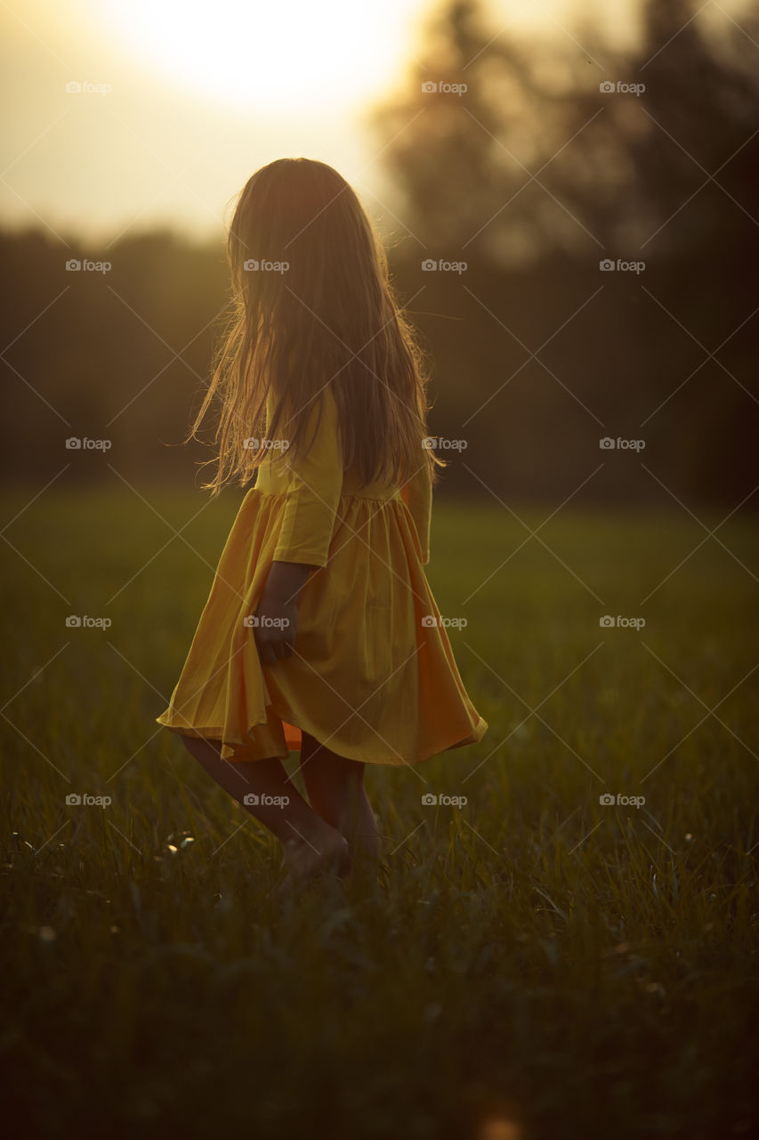 Little girl in yellow dress outdoor portrait 