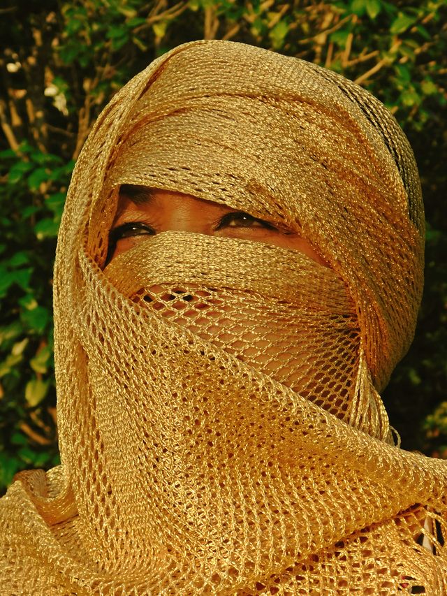 A women wearing a gold colored hijab - I love this photo - A portrait of a beautiful woman dressed in a gold veil. Principle of modesty, facial cover, gold, color of gold, chic, classy, head, face, golden, eyes, head, facial expression