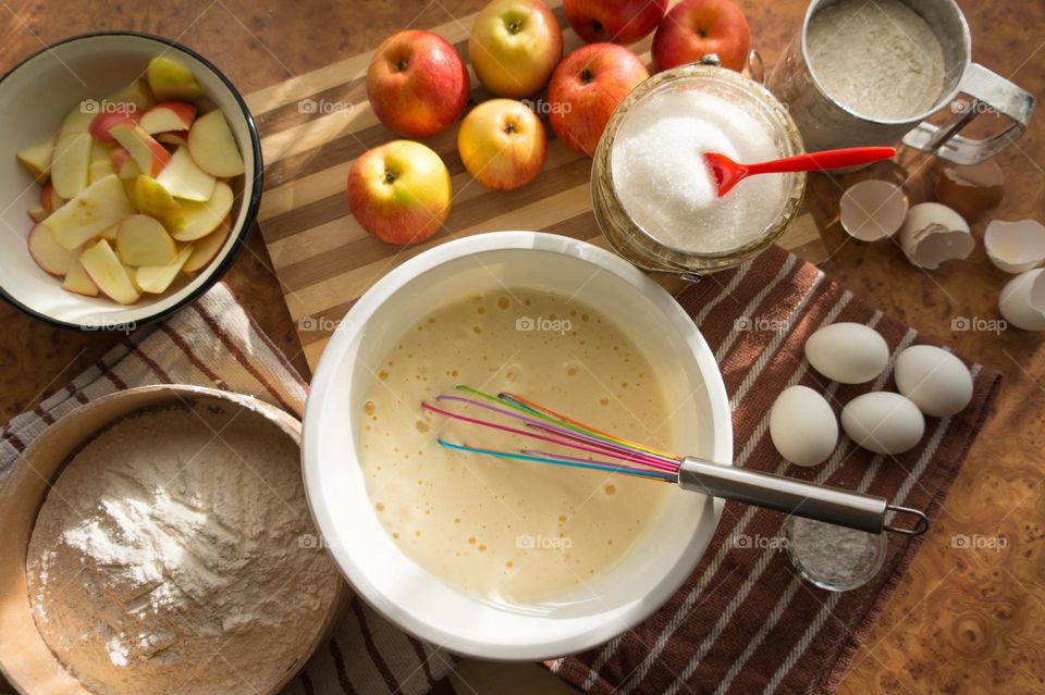 Making homemade puffed apple pie with eggs, sugar and flour.