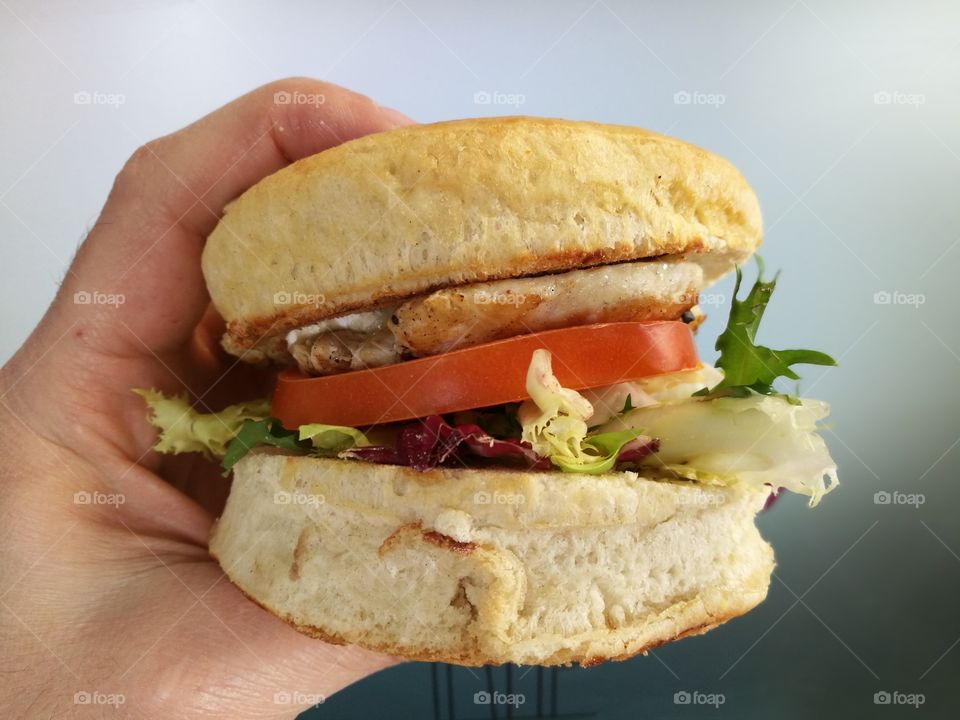 Close-up of person holding hamburger