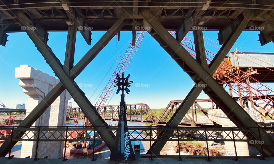 Artwork under a bridge overlooking a construction site