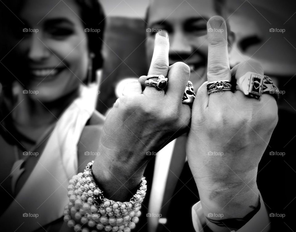 Fun wedding photo, couple having fun with wedding rings, Black and white wedding photography, silly wedding pose, punk style wedding 