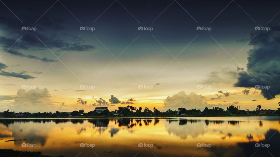 The warmth of the sunlight that reflects the water at dusk in Thailand.