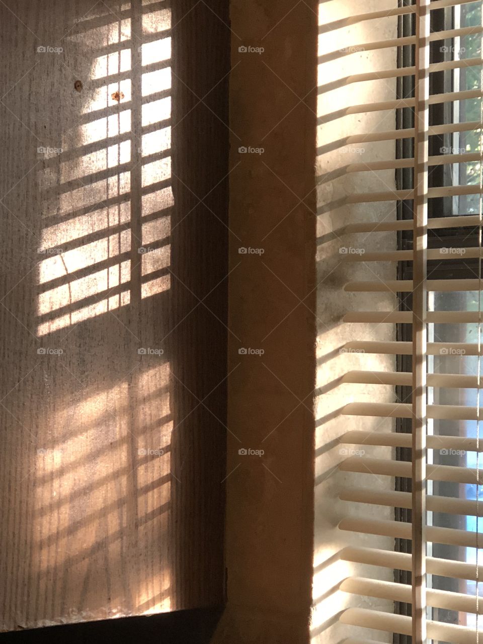 Gorgeous shadows coming from windows blinds make simple light beautiful