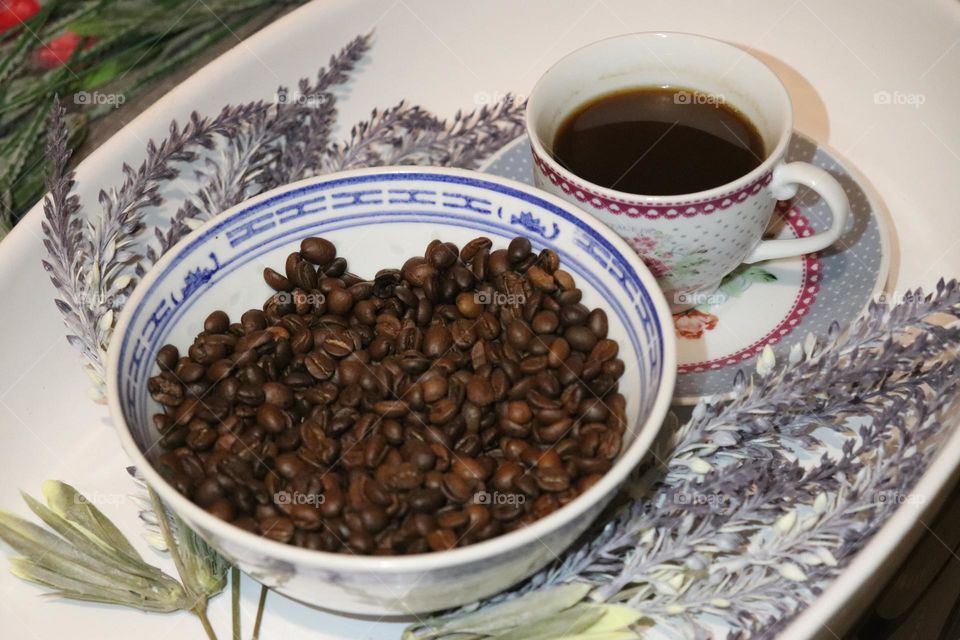 A cup of coffee and coffee beans