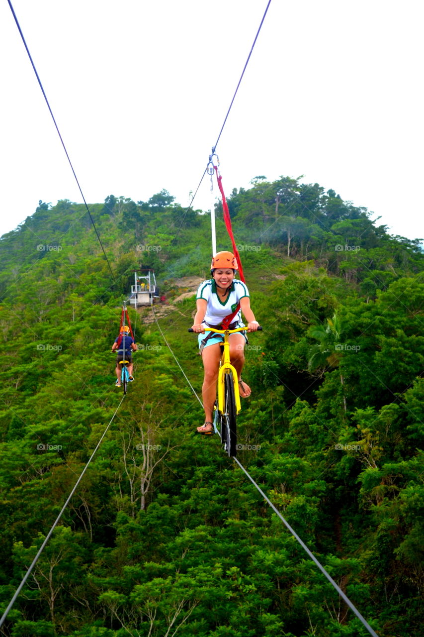 Smiling woman cycling on rope