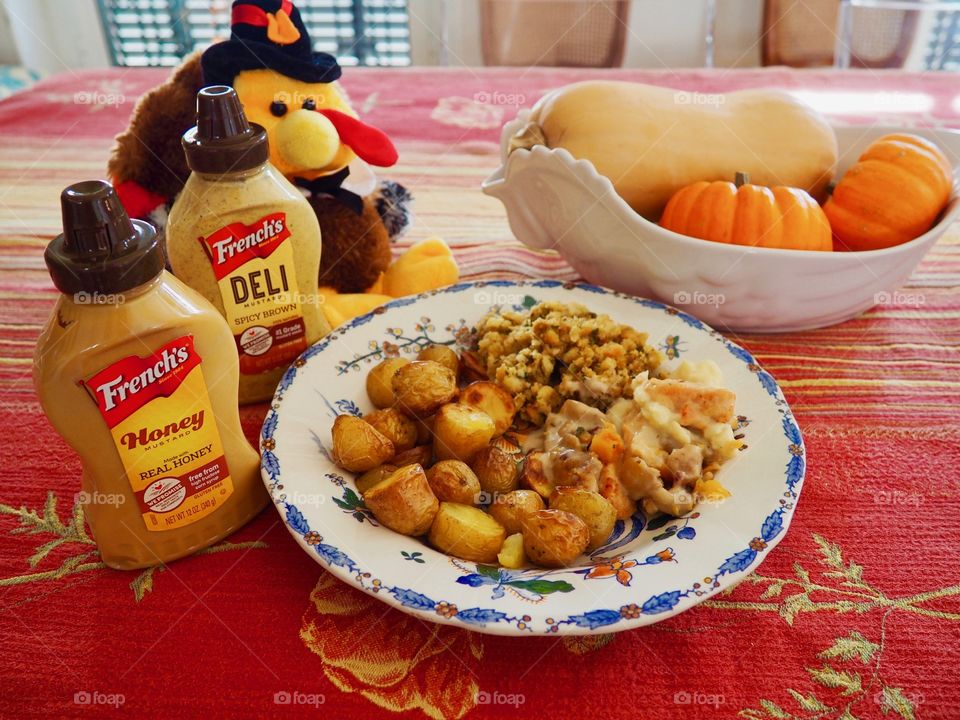 Thanksgiving plate of turkey in a creamy French’s deli and honey mustard sauce with stuffing and roasted potatoes.