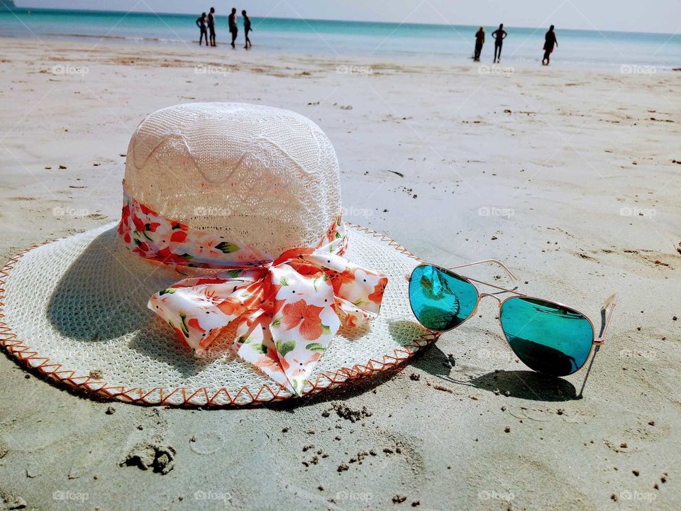 hat and sunglasses at beach