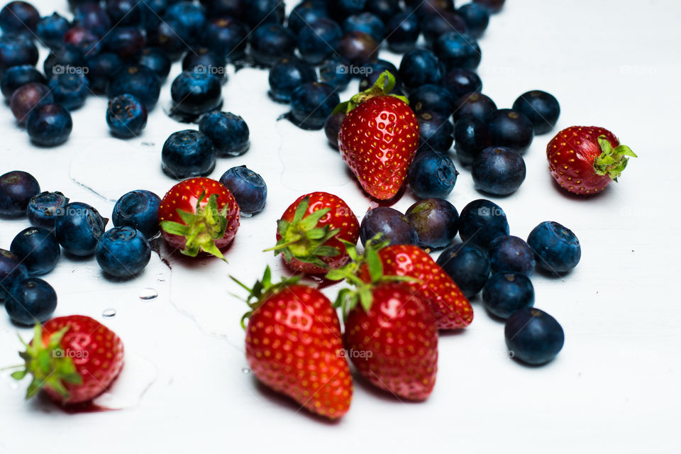 blueberries and strawberries on white background