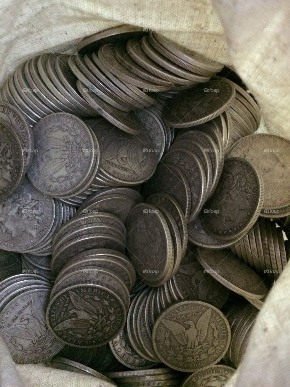 Morgan Dollars. A sack full of circulated Morgan silver dollars from various Mints. 