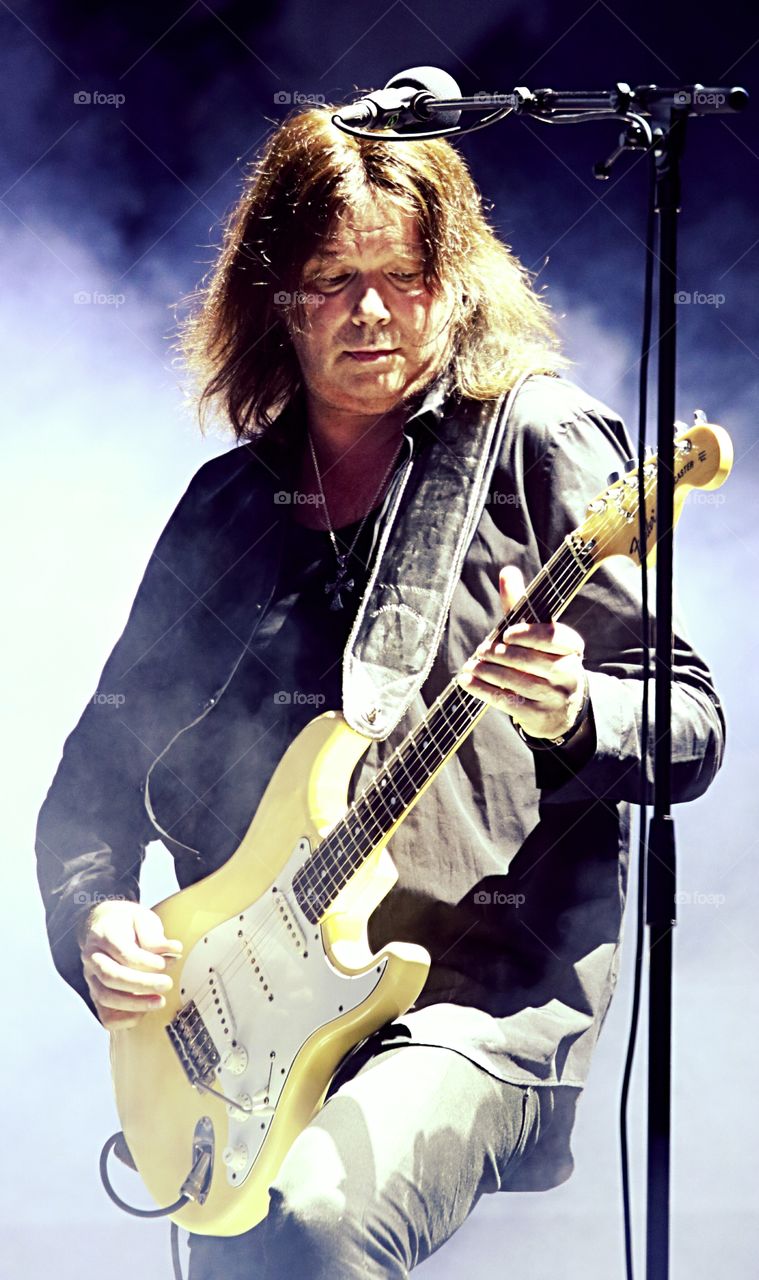 Man in concert playing guitar