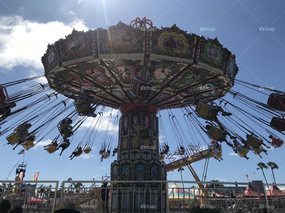At the kids carnival in the infield of Del Mar Race Track at the San Diego County Fair on July 2, 2018, we see the wonderful sight of one of the most popular merry go rounds at the Fair that people of all ages enjoy.