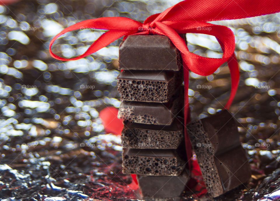 Slices of chocolate bar tied up with ribbon