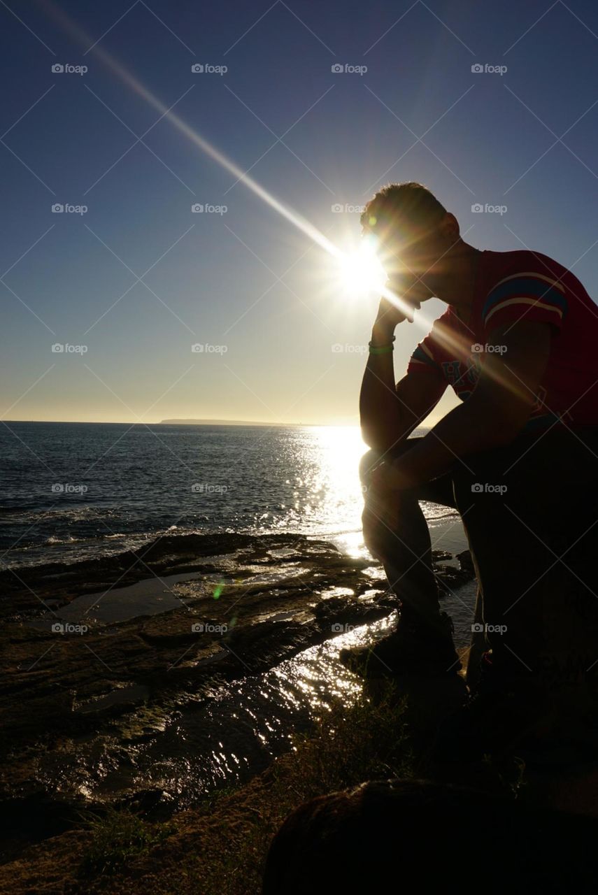 Sun#face#sea#rocks#human#sky