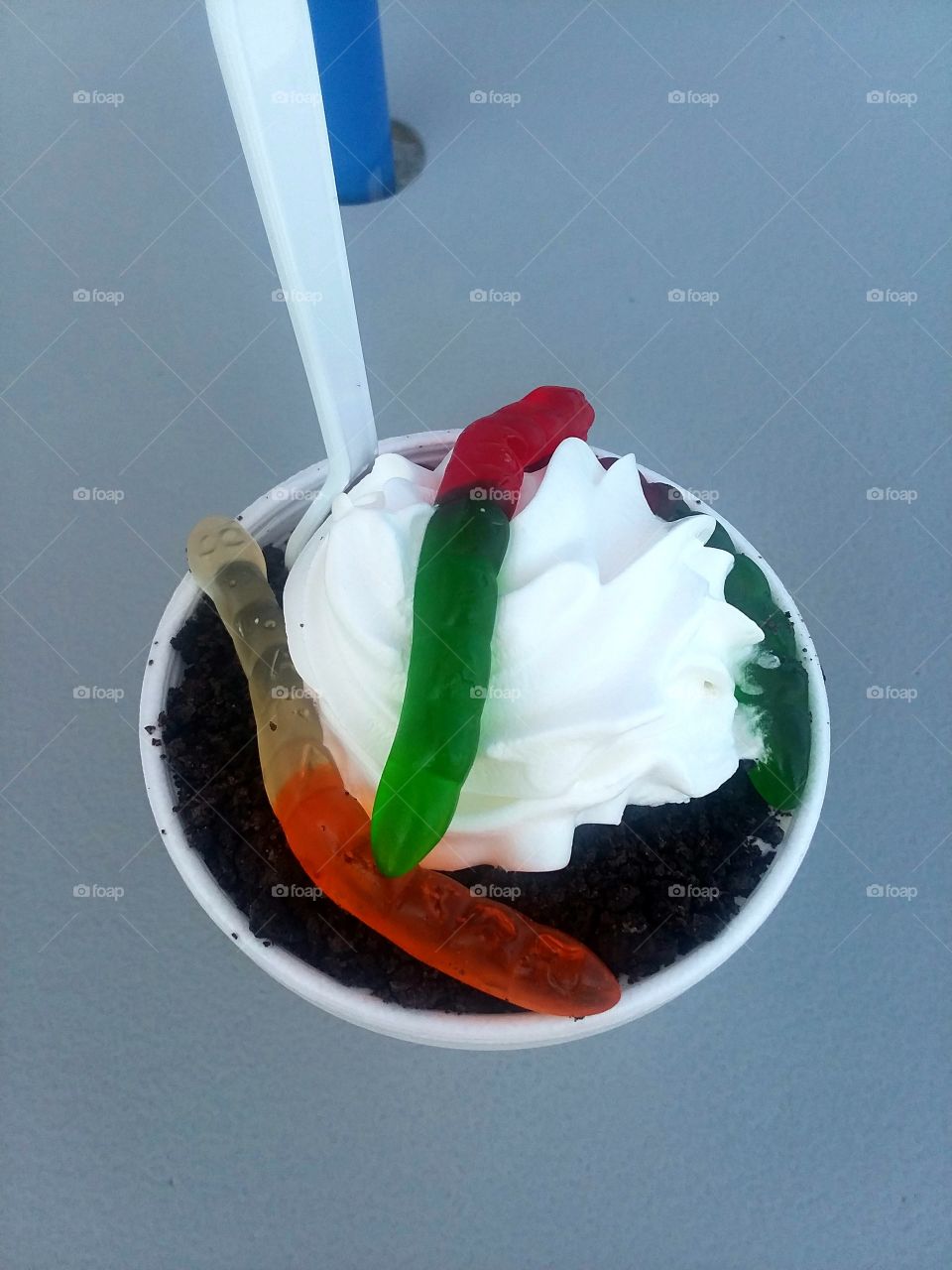 Gummy worm oreo ice cream sundae with whipped cream.