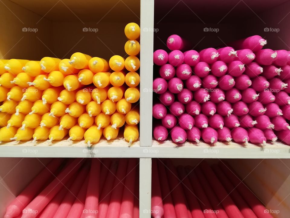 Colored candles on the shelf of the shop