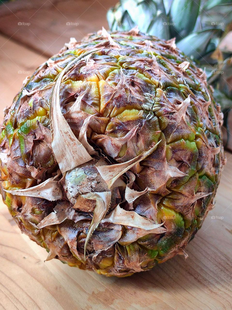 Pineapple lies on wooden boards