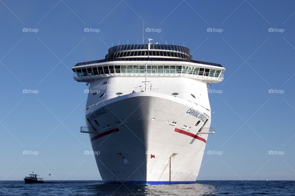 Straight on front angle of a Carnival cruise ship on a bright, clear day