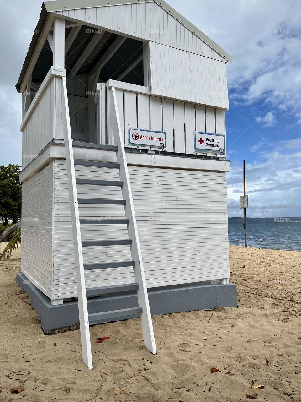 White wooden emergency cabin on a Caribbean sandy beach