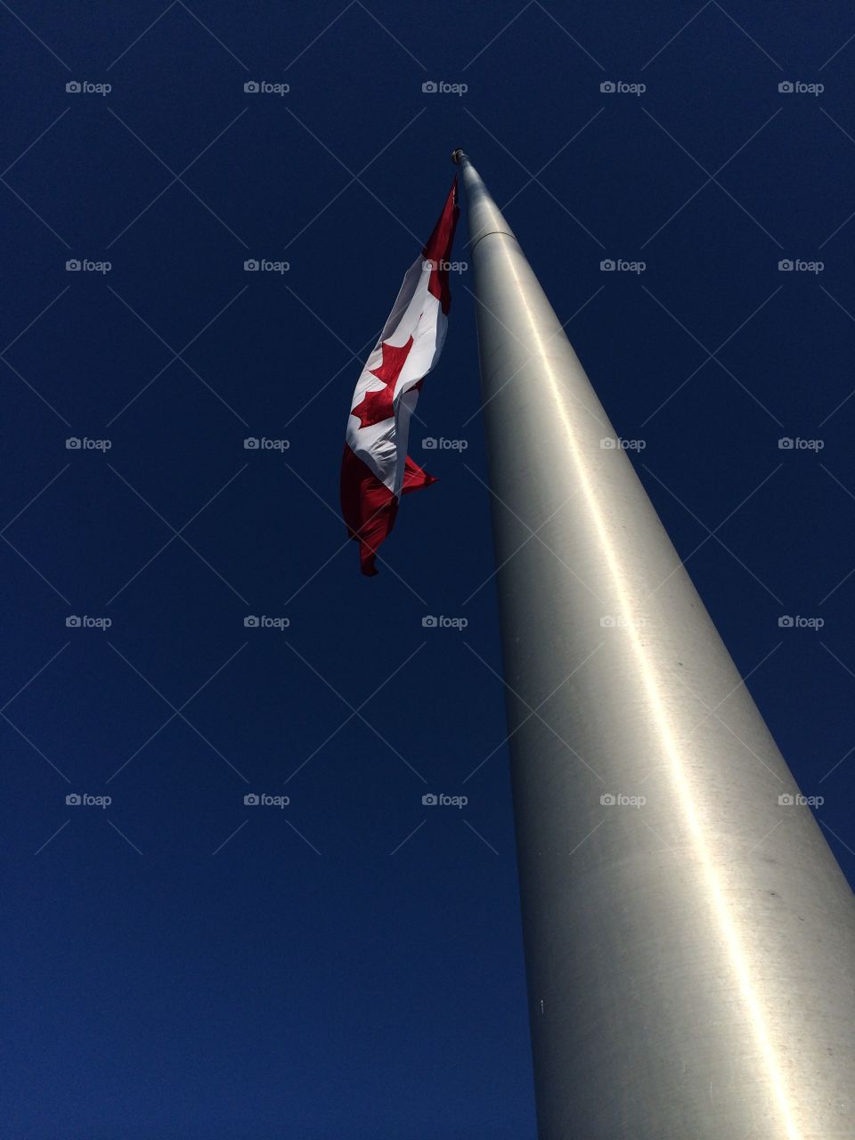 Low angle view of Canadian flag on pole