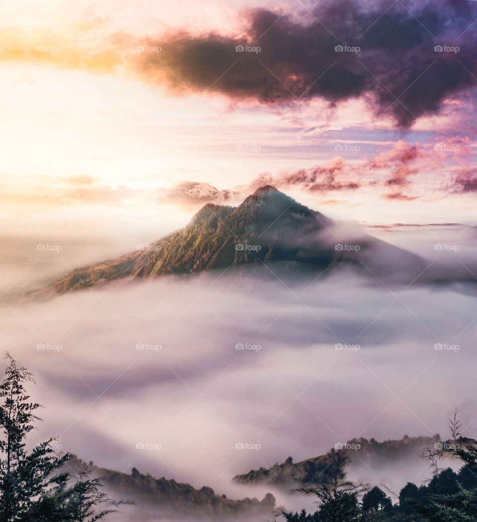 Amazing sunrise with a mountain view in the middle of the clouds