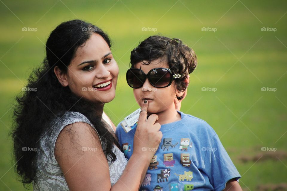 Happy young mom with her four year old son in outdoor park 
