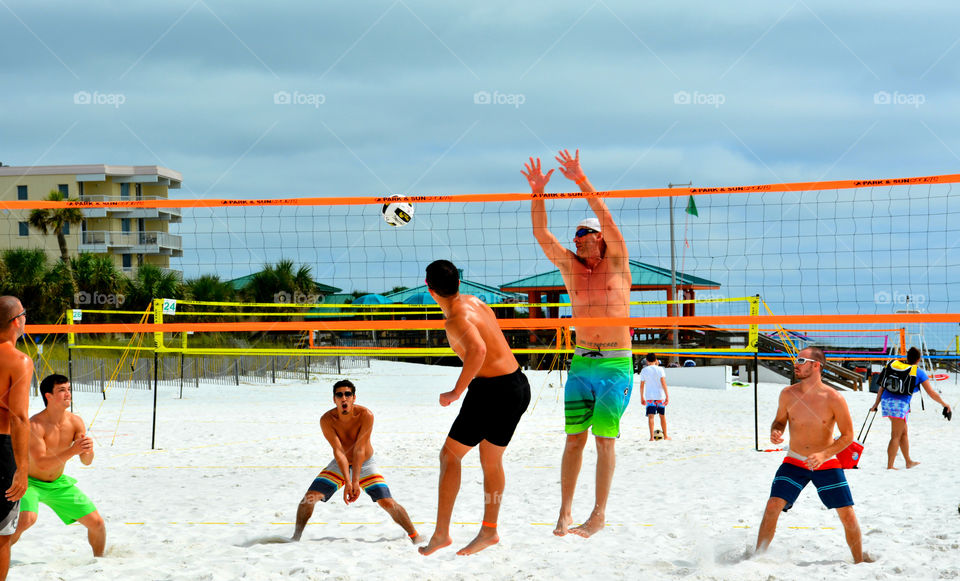 Visitors and locals play a game of pickup volleyball on the beach in front of the Gulf of Mexico!