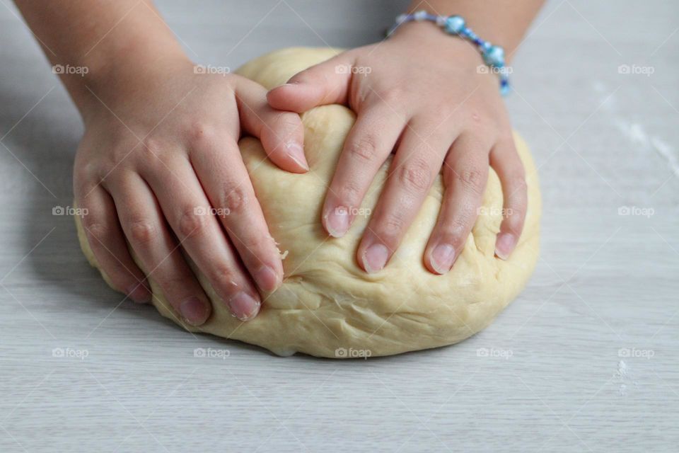 Girl's hands are clealing bread dough