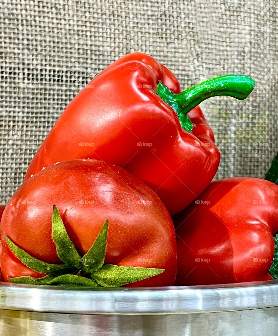 Peppers and tomato in an iron bowl