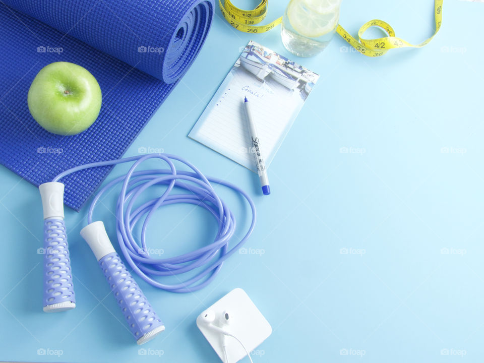 Exercise Flat lay with yoga mat water and a fruit