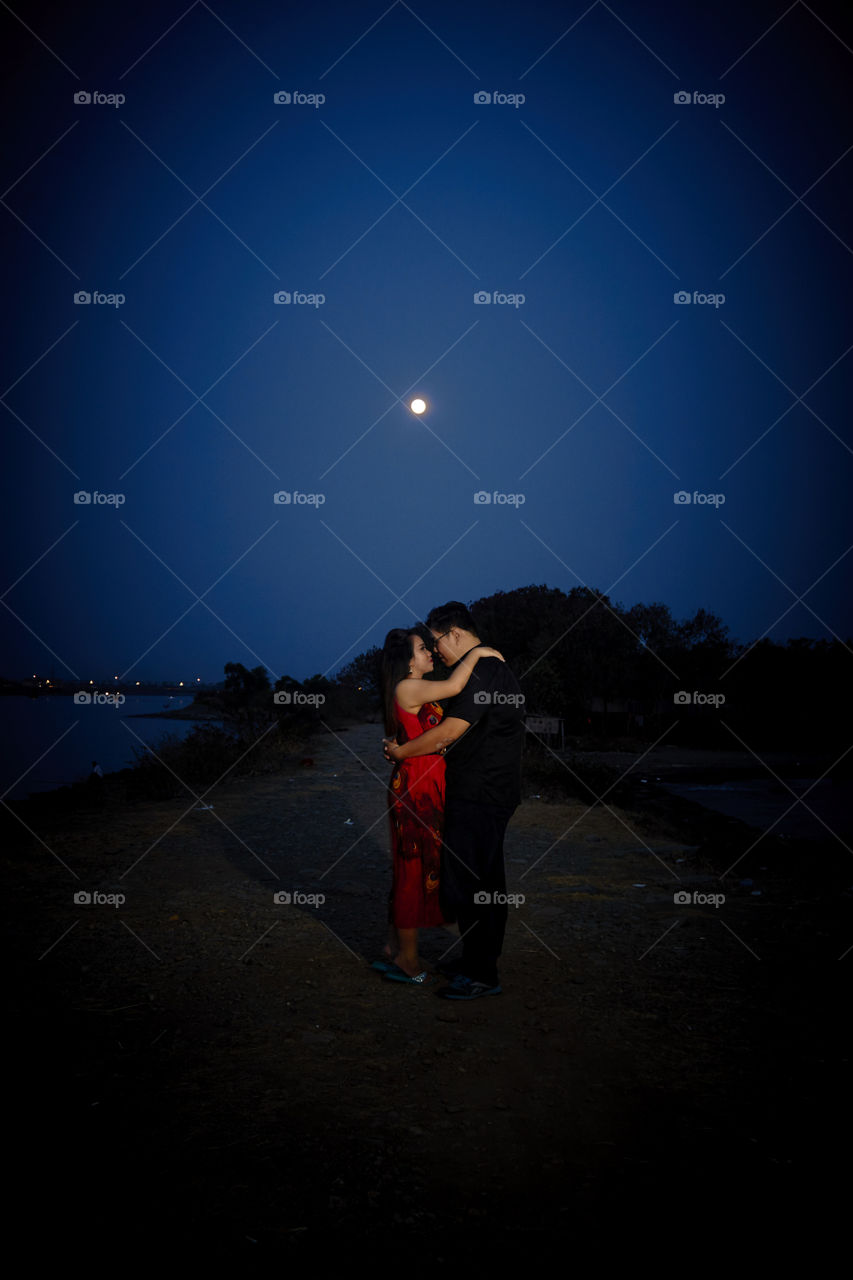 Cuddling under the moonlight. A short pre-wedding shoot, a couple requested to be shot on the beach, however when the sky turns dark, the shoot change