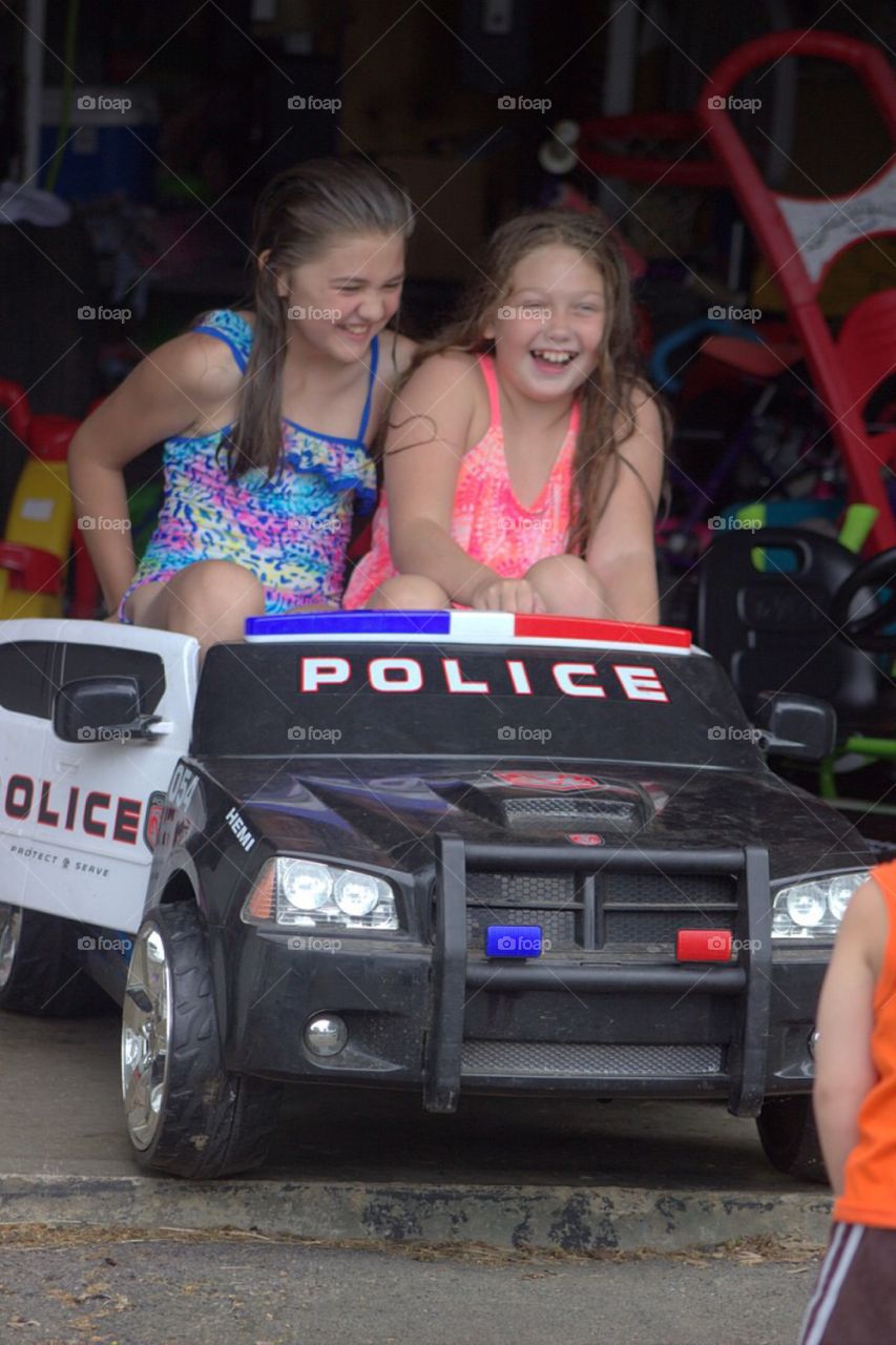 Two girls enjoying in toy car