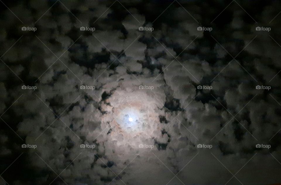 moon between clouds,moon,spiral,clouds,sky,landscape,nature,shining,cloudy,evening,night