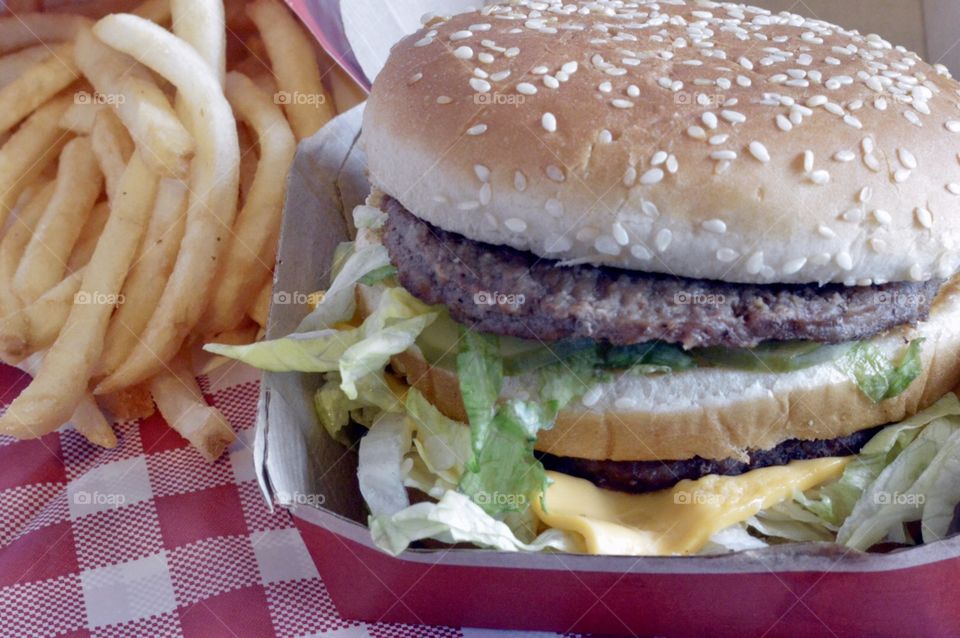 McDonald’s big Mac and a large fry on a red and white checkerboard back ground
