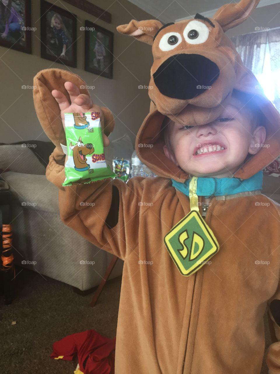 Cite boy holding candy wrapper in hand