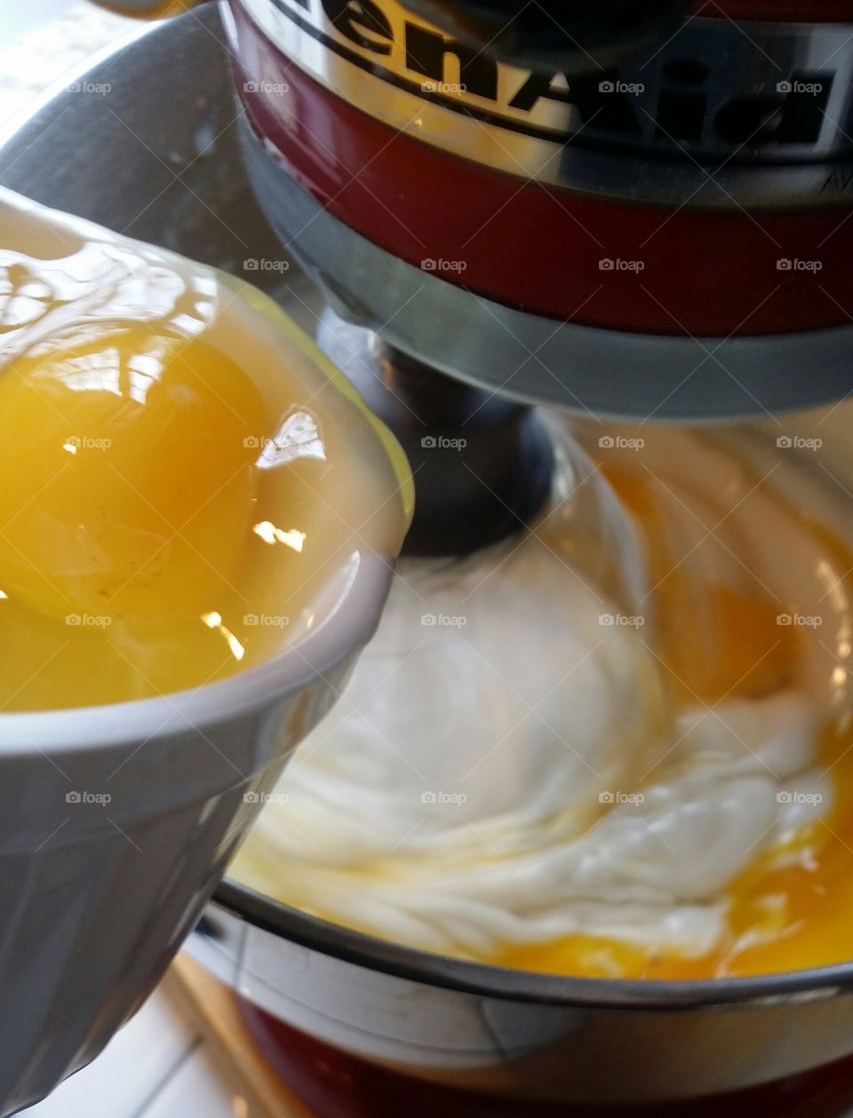 Adding eggs to mixer